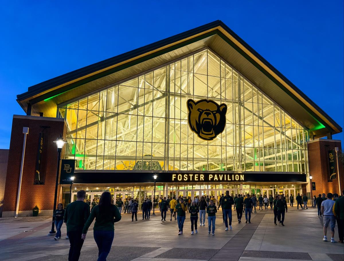 Baylor's Foster Pavilion arena at dusk with its lit glass gable front and bear logo