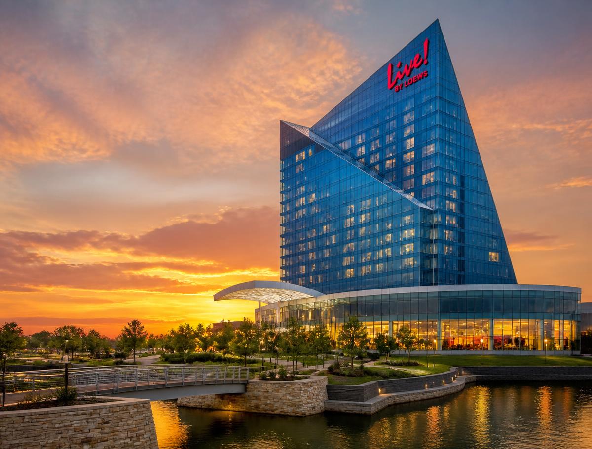 Live! by Loews hotel tower in Arlington at sunset above a landscaped waterfront plaza