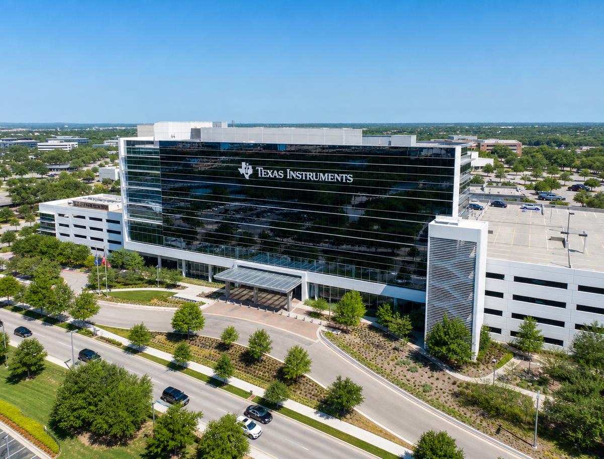 Aerial view of the Texas Instruments corporate campus building with dark glass facade